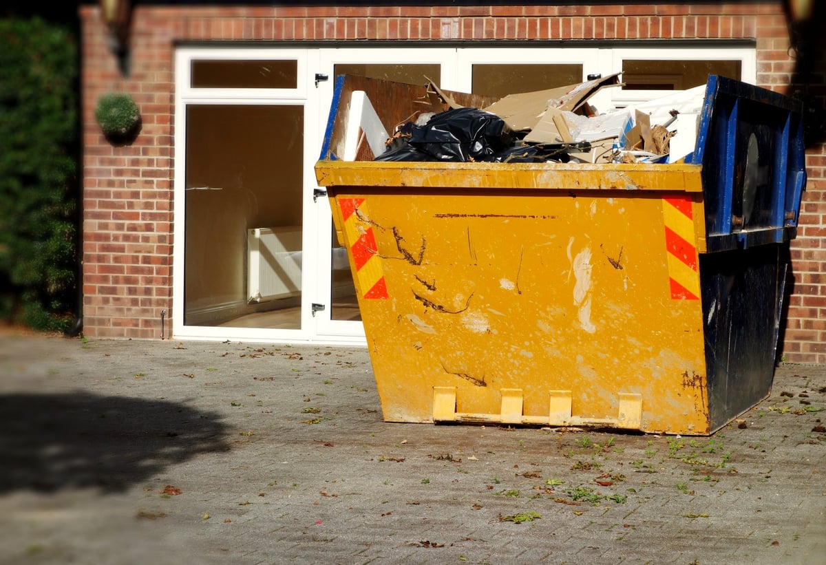 Mini dumpster filled with construction and renovation debris in front of a Berkeley home